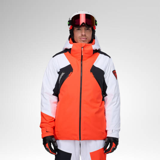 Giacca Rossignol Hero 4-Way Stretch Puffy Neon Red indossata con casco